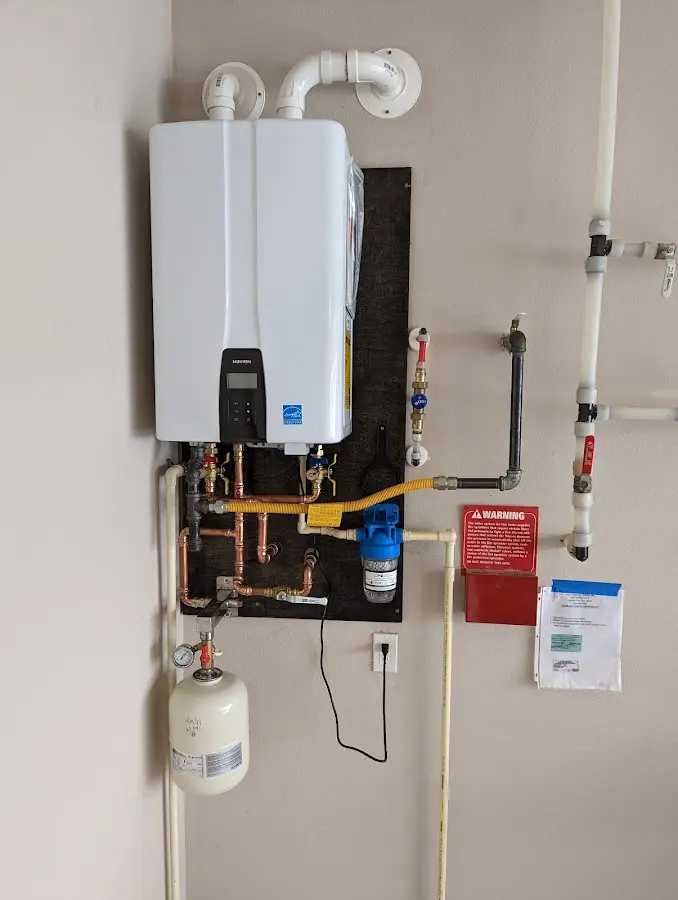 Professional plumber installing copper piping in a Greenacres home